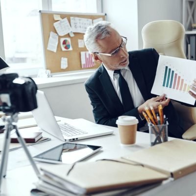 senior-man-in-elegant-business-suit-showing-chart-2023-11-27-05-16-17-utc.jpg